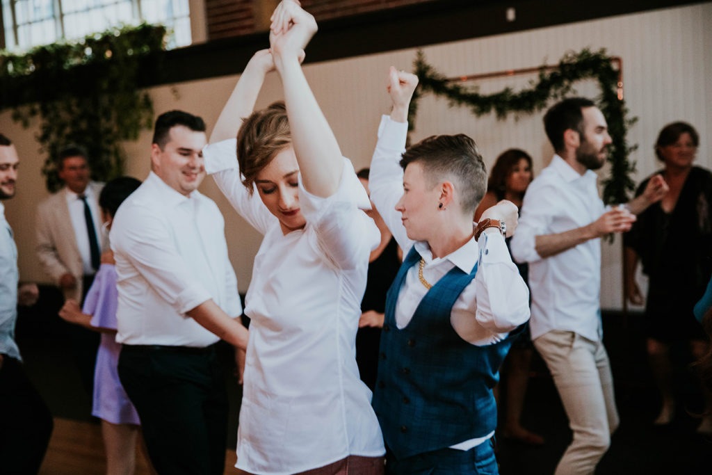 LGBTQ+ couple dancing at their wedding